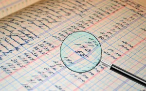 Magnifying glass on a paper being audited