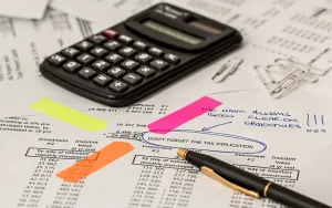 Calculator and biro on top of paper