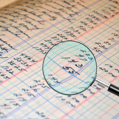 Magnifying glass on a paper being audited